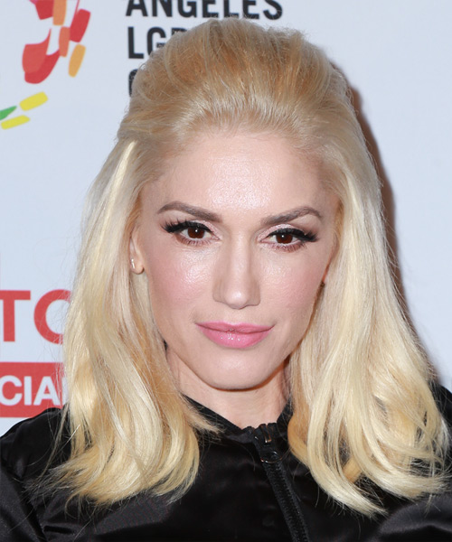 Gwen Stefani wears a half up puff hairstyle in platinum blonde