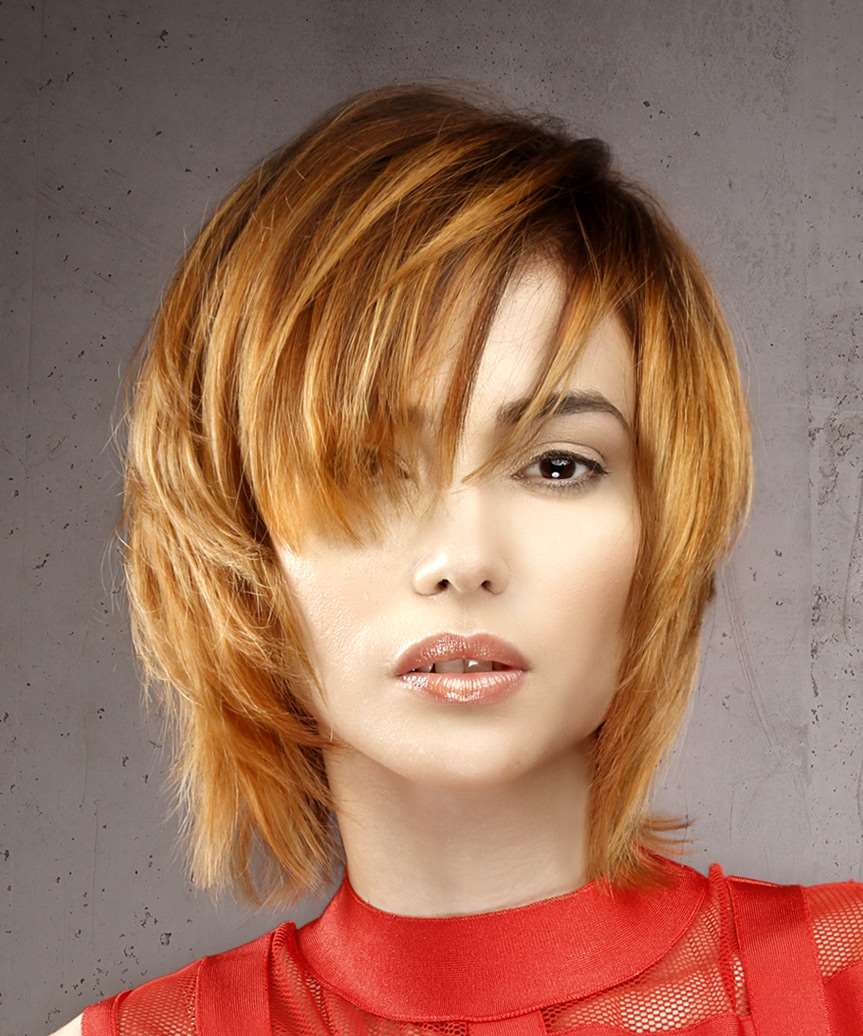 Shag layered medium length hairstyle with copper and blonde highlight bayalage