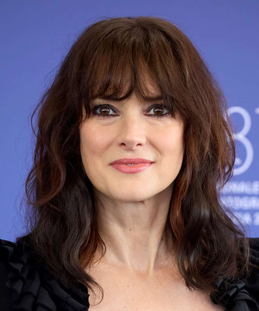 Winona Ryder Hairstyle With Classic Bangs And Beach Waves