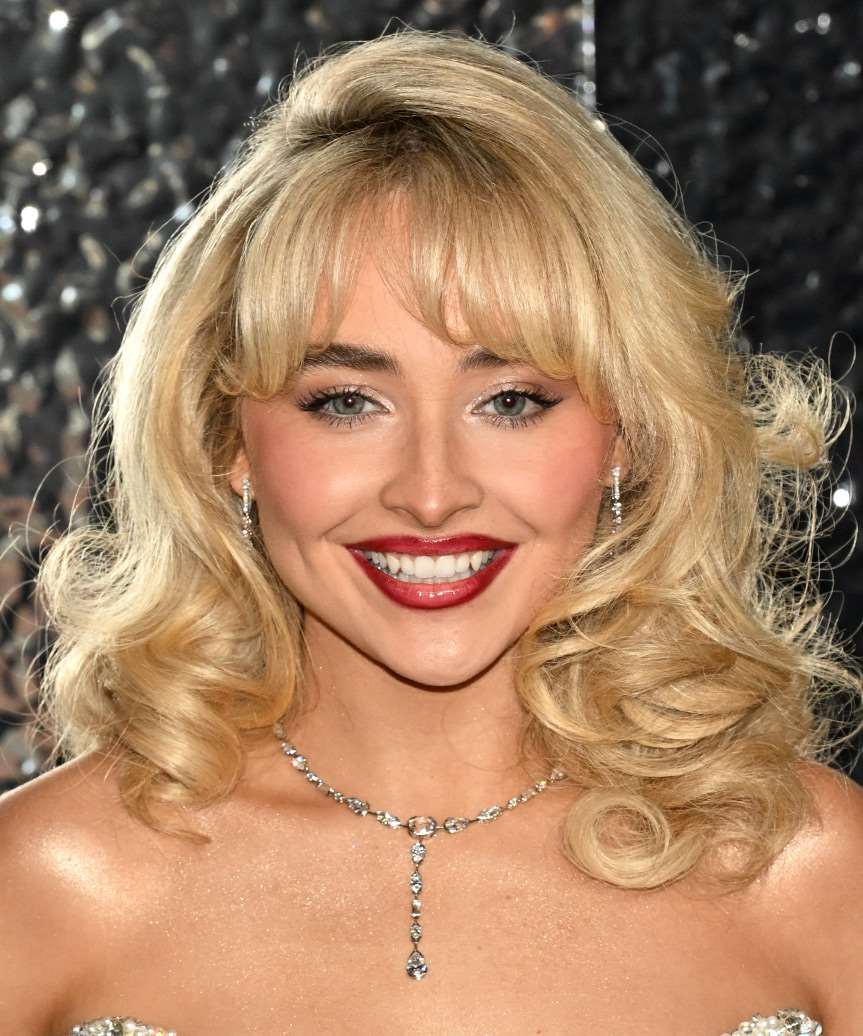 Sabrina Carpenter Hairstyle With Classic Bangs And Bold Curls