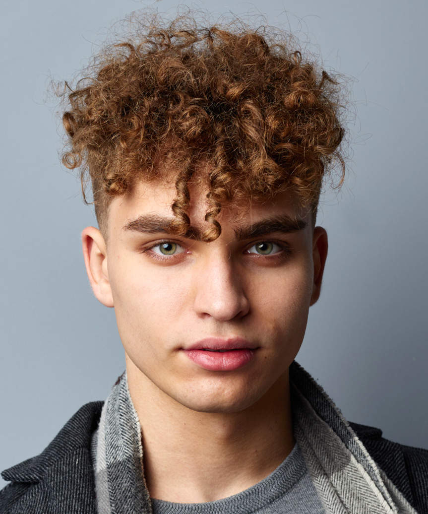 Short Male Hairstyle With Very Short Sides And Natural Curls