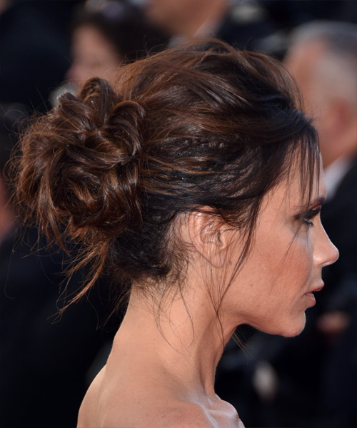 Victoria Beckham wears a formal up-do puff hairstyle