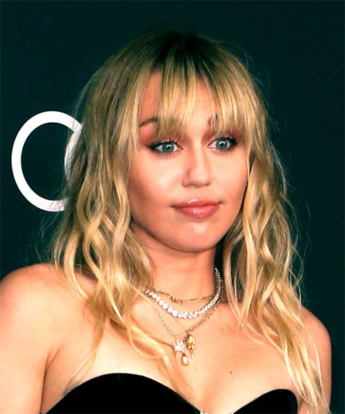 Miley Cyrus Medium Wavy Blonde Hairstyle with Blunt Cut Bangs