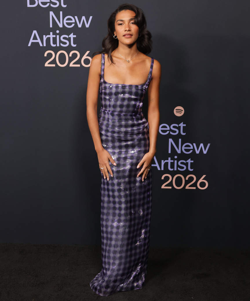 Olivia Dean Side-Swept Hairstyle With Bold Curls - view from the side