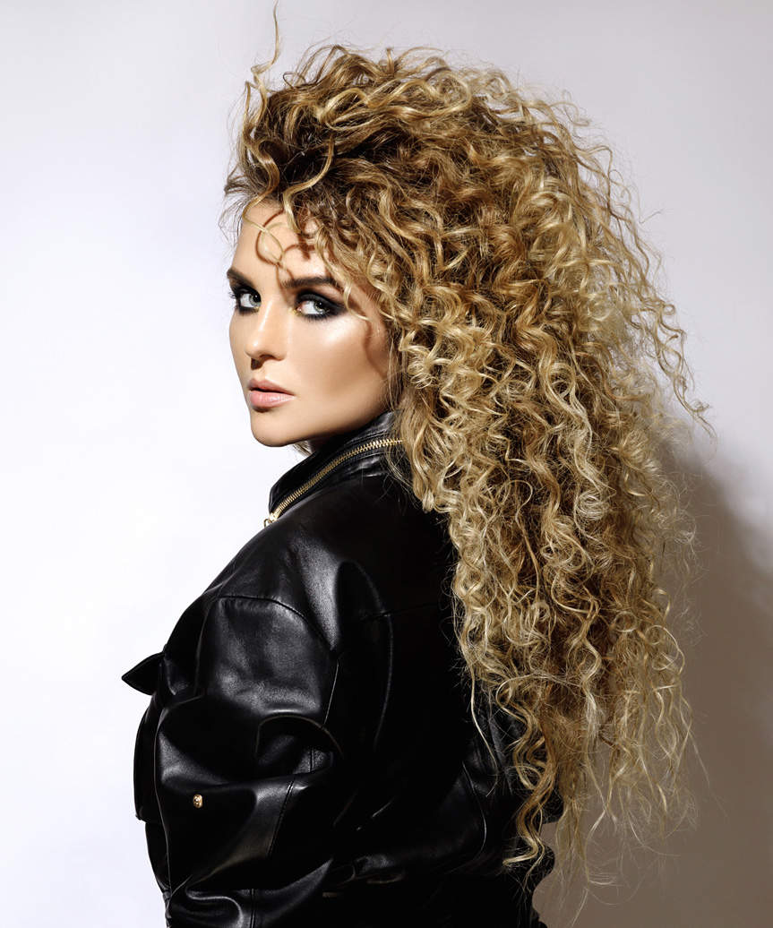Long Voluminous Hairstyle With Bold Curls - side view