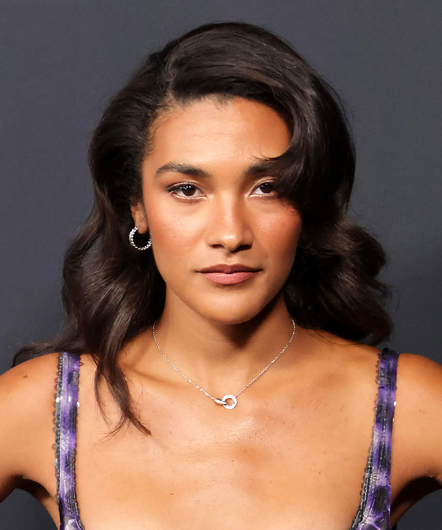 Olivia Dean Side-Swept Hairstyle With Bold Curls - side view