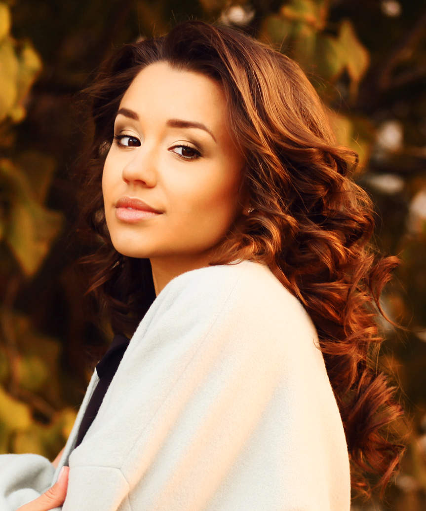 Long Voluminous Hairstyle With Mid-End Curls - side view