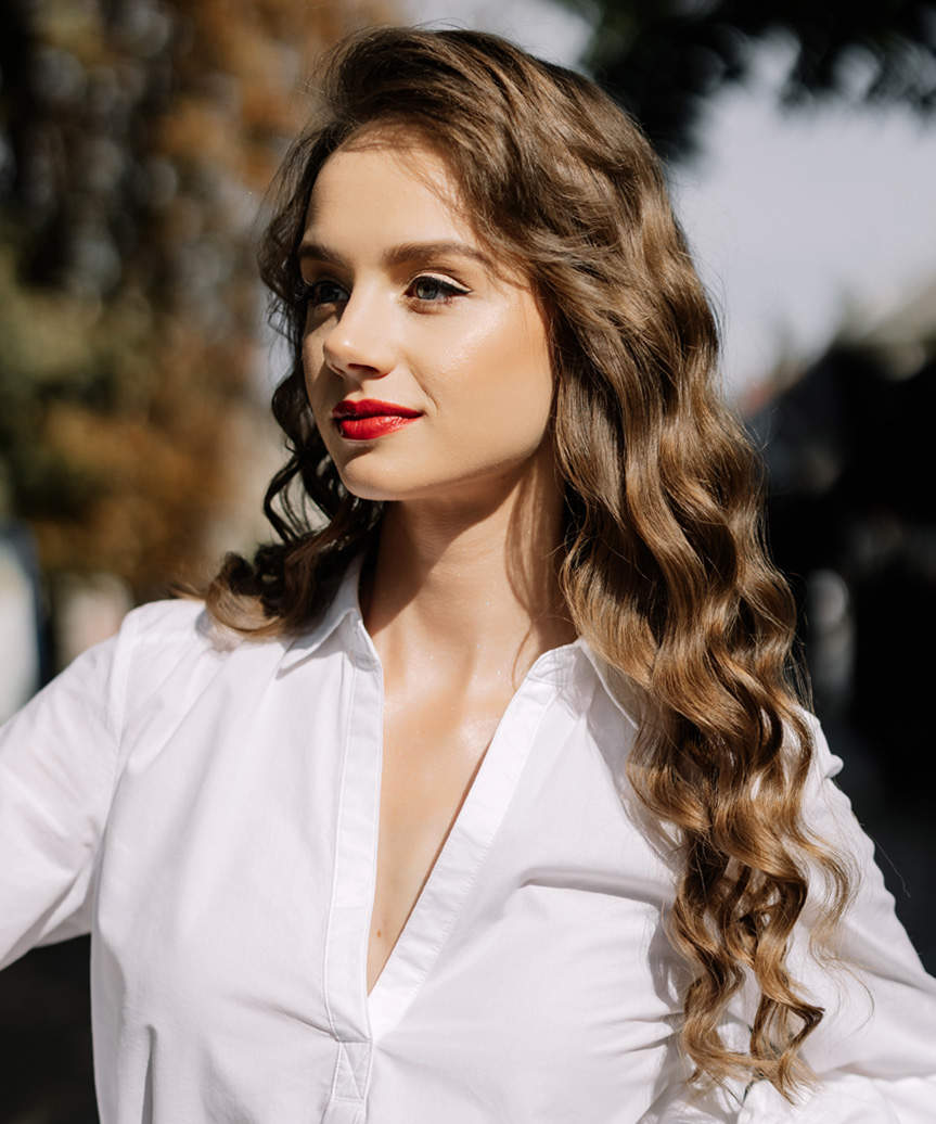 Long Hairstyle With Tight Curls And Deep Side Part - side view